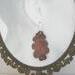 Copper Oak Leaf Earring on Framed photo of head