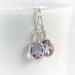 Faceted lavender amethyst gemstone earrings bezel set in sterling silver with wire wrapped accents and sterling silver ear wires.