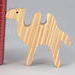 Handmade unfinished wood toy camel from the Itty Bitty Animal Collection sanded smooth and ready to paint. Ideal for kids' crafts or toys, this freestanding camel can be stacked with similar toys for a playful experience.