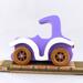 A handmade wooden toy car vintage style coupe painted nontoxic purple and white with spoked wheels finished with nonmarring amber shellac, from my  Bad Bob's Custom Motors Collection.