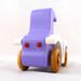A handmade wooden toy car vintage style coupe painted nontoxic purple and white with spoked wheels finished with nonmarring amber shellac, from my  Bad Bob's Custom Motors Collection.