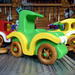 A handmade wooden toy car vintage style coupe painted nontoxic bright green and yellow with spoked wheels finished with nonmarring amber shellac, from my  Bad Bob's Custom Motors Collection.