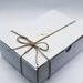 white gift box with string bow tied
