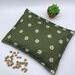 green fabric with daisies cherry pit heating pad
