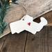 Massachusetts state -shaped ornament in white ceramic clay. Gloss glazed with a red impressed heart in the area of Boston. silver cord
