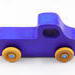 A handmade wooden toy pickup truck painted with bright blue and metallic sapphire blue paint. The wheels are finished with non-marring amber shellac. This toy is part of my Play Pal Collection.