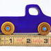 A handmade wooden toy pickup truck painted with bright blue and metallic sapphire blue paint. The wheels are finished with non-marring amber shellac. This toy is part of my Play Pal Collection.