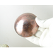 photo showing backside of hand hammered copper trinket bowl 3 inch diameter in gloved hand