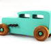 Handmade wooden toy car based on a 1932 Hot Rod Sedan painted  Turquoise with Metallic Green and Black trim. It has nonmarring Amber Shellac Wheels.