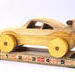 Handmade wooden toy car coupe finished with nontoxic clear, amber shellac and contrasting wood trim. It's one of ten cars in my Speedy Wheels Collection.