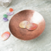 photo showing hand hammered copper trinket bowl 3 inch diameter shown with small oval tokens with "moody" and "neutral" stamped. Third token is left blank.