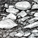 Photo of small drawing of rocks in black and white ink,