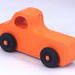 A handmade wooden toy pickup truck painted Pumpkin Orange and Black from my Play Pal Collection