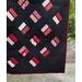 Bold geometric quilt in red and black, handmade in USA