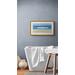 A Day At The Beach Fine Art Print shown on an example wall in a bathroom setting with a white border and a light stained wooden frame.