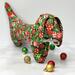 Stuffed Dachshund with red and green ornaments all over