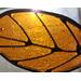 Stained glass leaf with wire detail in sunlight
