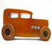 This handmade wooden toy car is based on a 1932 Ford Sedan Hot Rod. It is hand-finished with multiple coats of amber shellac and trimmed with black and grey acrylic paint.
