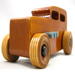 This handmade wooden toy car is based on a 1932 Ford Sedan Hot Rod. It is hand-finished with multiple coats of amber shellac and trimmed with black and grey acrylic paint.