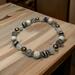 White lava rock and glass beads on a stretch cord.