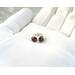 Simple gemstone stud earrings, 6mm round smooth red garnet gemstone set in 999 fine silver bezel cup, 925 sterling silver post and butterfly earnut, shown in gloved hand