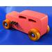 Handcrafted pink wooden hot rod '32 sedan toy car. Features black and metallic sapphire blue accents, and non-marking amber shellac wheels. Made to order for unique play or display.
