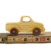 Handmade wooden toy pickup truck finished with a blend of mineral oil and beeswax and painted with metallic sapphire blue trim.