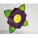 A stained glass purple flower with yellow center and green leaves, on a neutral background