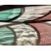 Refraction of stained glass Easter Egg on a neutral background, featuring pastel teal, clear, and plum stripes.