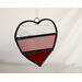 Stained glass heart in red, rose and clear stripes