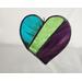 A stained glass heart featuring teal, green, and purple stripes
