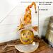 This image shows a handmade pumpkin decoration. The pumpkin and hat measure 21 inches tall. The hat brim is 11 inches wide.