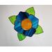 Blue stained glass flower with caramel center and green leaves