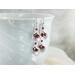 Garnet and rhodium-plated dangle calla lily earrings.