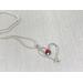 Wire wrapped garnet and sterling silver heart necklace.