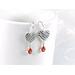 Silver heart earrings with bezel set orange citrine gemstones.