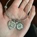Bracelet on hand showing size comparison.