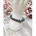 This enchanting stretch bracelet is comprised of blue sea opal and dyed quartz beads, and is about 7 inches.