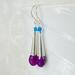 Faceted purple chalcedony teardrops topped with long sterling silver cones and blue apatite beads with sterling silver ear wires.