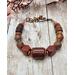Bracelet is comprised of jasper, tiger eye, and agate with copper accents. The handmade hook clasp allows for some flexibility in length.