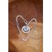 Silver fingerprint charm necklace encircled by forever in my heart accent charm on natural wood background.