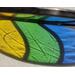 Refraction of a Stained glass Easter Egg on a neutral background, featuring yellow, green, and blue stripes