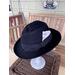 Black fedora with molded skull on crown