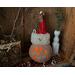 This image shows the Christmas gourd lit up with a battery-operated candle. It lights his happy face and snowflakes carved into the shell