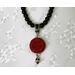 Black choker style necklace with red pendant