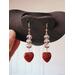 Light Gray Beaded Dangle Earrings with Red Banded Heart Charm dangles on a jewelry display.  The red bands are darker than the charm.