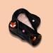 Preteen/teen cloth menstrual pads with pink 100% organic cotton core sits on black cotton fabric and Red Fox print fabric Pink background