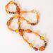 Long orange beaded necklace.