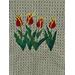 Red and Yellow Tulips on a green mist colored towel