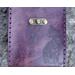This Premium Handmade Leather Tarot Card Case features familiar felines silhouetted against a deep violet. Close up of cat on front of case to show intricate design.